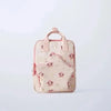 A light pink fashion backpack with a cow print pattern and pink accents.