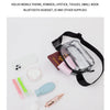 A clear PVC waist bag with an adjustable black strap is shown holding various small items like a phone, powder, and tissues.