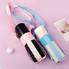 A pink and blue crossbody sling water bottle bag with a black bottle and white accents.