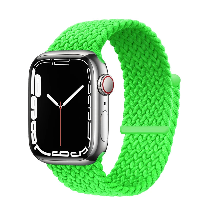 A green braided stretch band is shown around an Apple Watch.