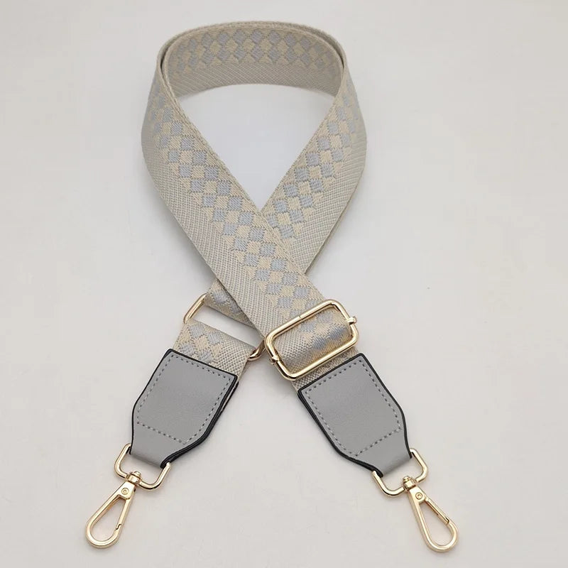 A beige braided nylon bag strap with metal hooks shown against a light background.