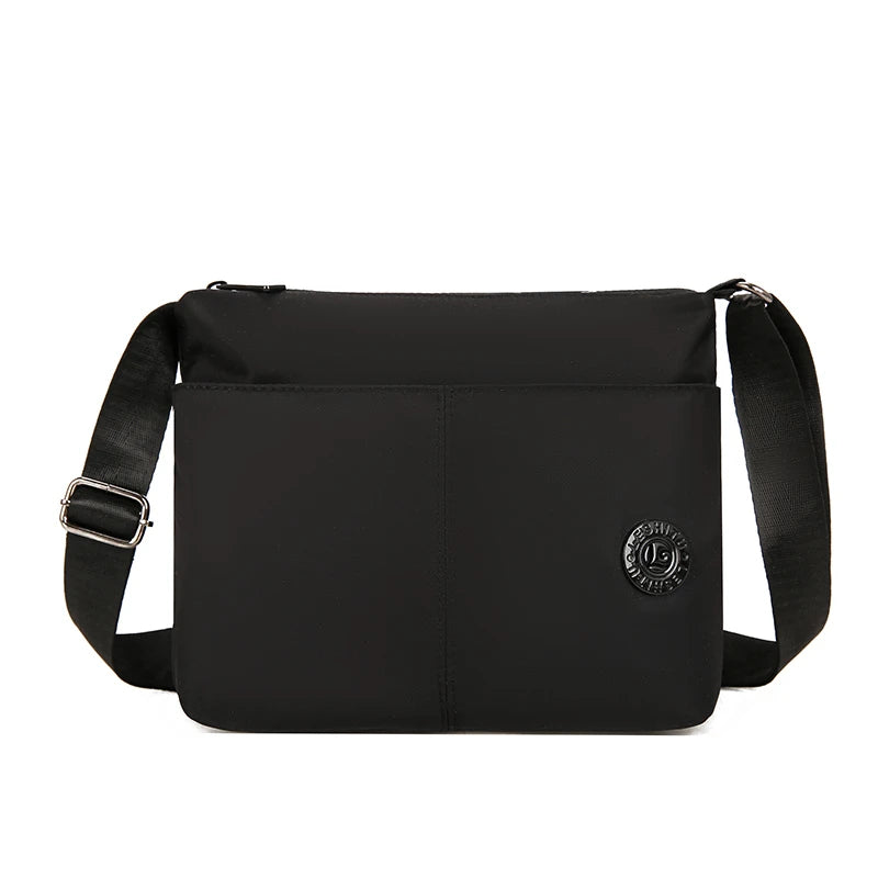 Black waterproof nylon crossbody bag with a flap and shoulder strap.