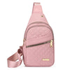 A pink quilted crossbody sling bag with a zipper and leather strap.
