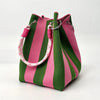 A pink and green striped retro knitted bucket handbag with pink cord handles.