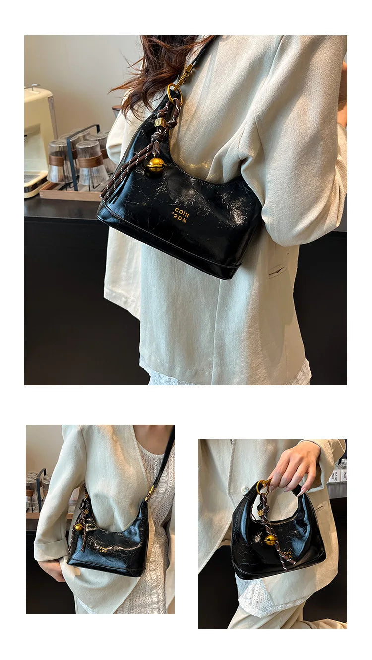 A black retro PU leather shoulder bag with gold hardware is shown against a light-colored shirt.