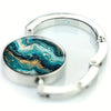 Silver bangle with a polished teal and gold marble pattern inlay
