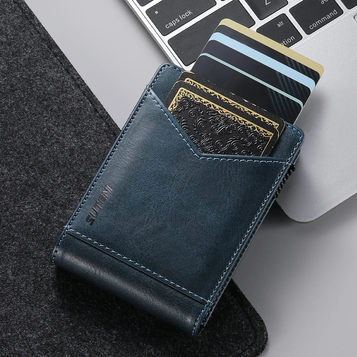 A dark blue PU leather card holder with a textured design and a credit card inside, resting on a gray surface.