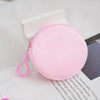 A pink capacity backpack with a zipper and pink strap resting on a white surface.