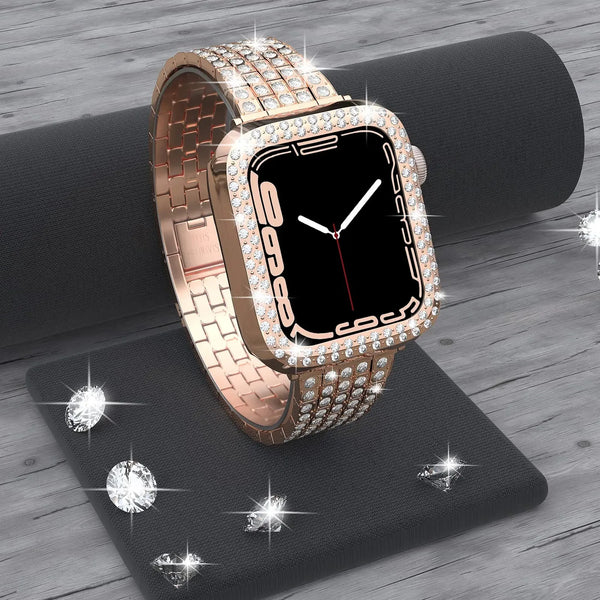 A rose gold Apple Watch is displayed on a black surface with scattered diamond rhinestones.