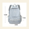 A light gray polka dot nylon travel backpack with a laptop compartment shown from the front.