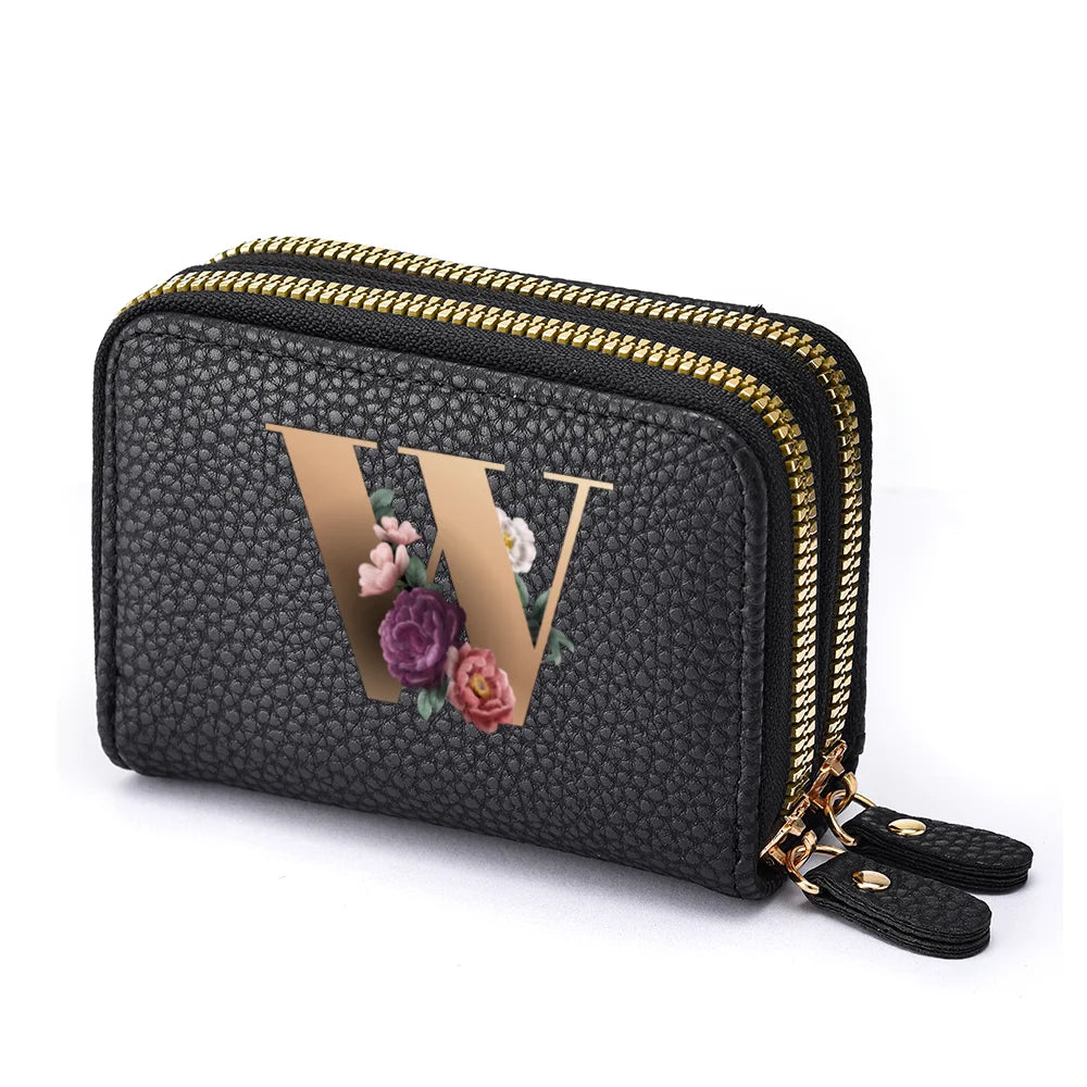 Black mini wallet with a gold letter W print and a double zipper closure