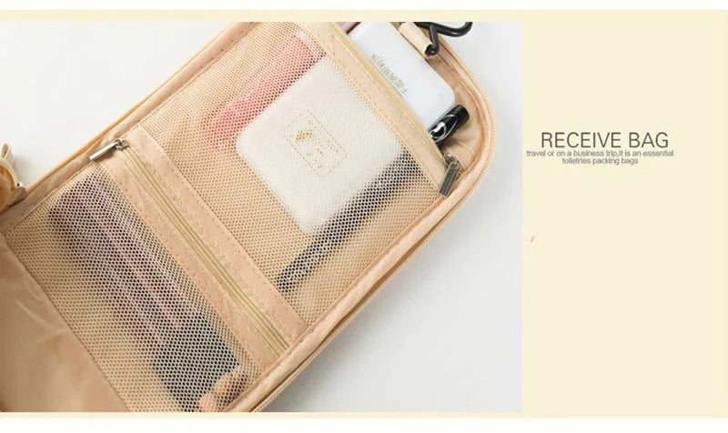 A tan multi-compartment travel pouch with a floral print lining and a white cosmetic item visible.