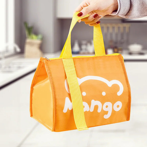 An orange cartoon insulated lunch bag being held by a hand.