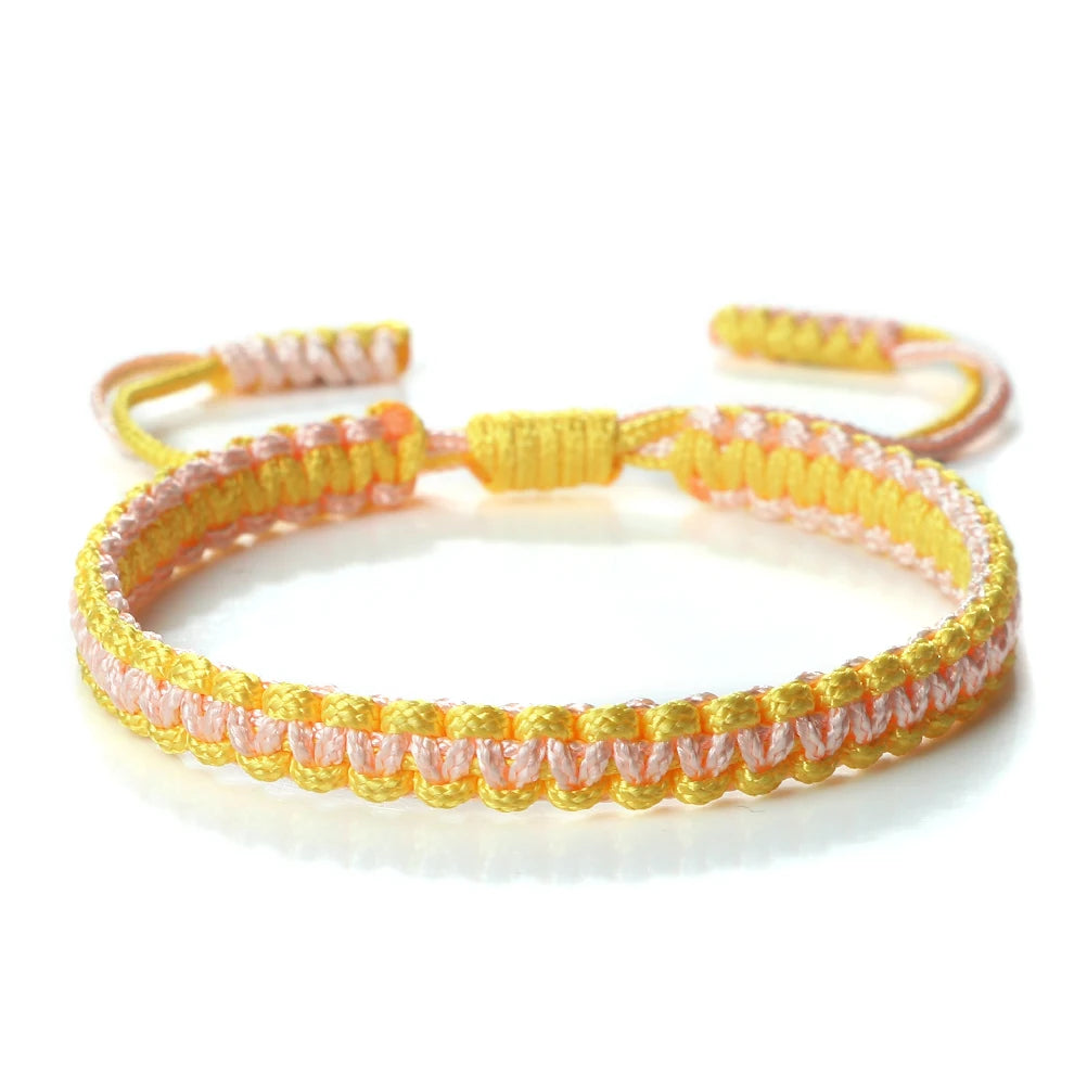Handmade braided rope bracelet featuring colorful pink and yellow threads.