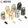 A collection of metal cord lock buckles in gold and black finishes for bags, straps, and crafts.