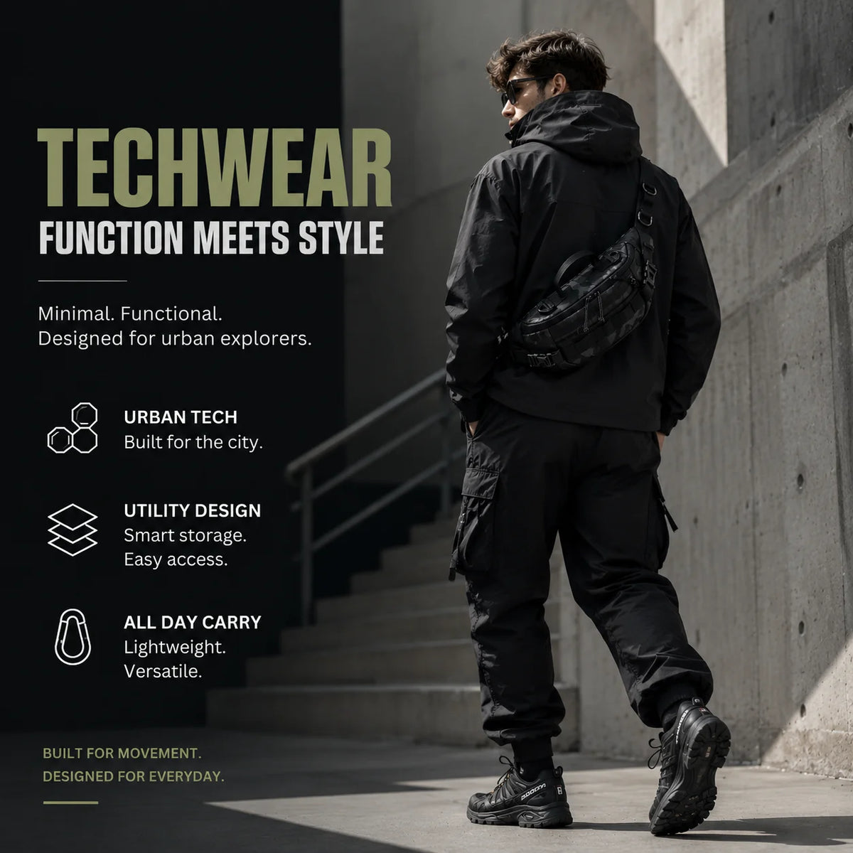 A man wearing a black techwear jacket and pants with a tactical sling waist pack stands on an outdoor staircase.