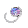 Silver folding table bag hook with a round glass charm featuring iridescent purple and blue colors