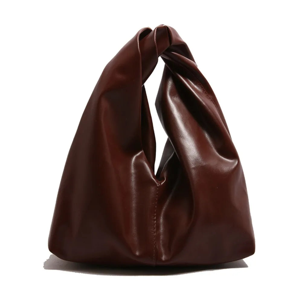 A dark brown leather minimalist crossbody tote bag folded and displayed on a white background.