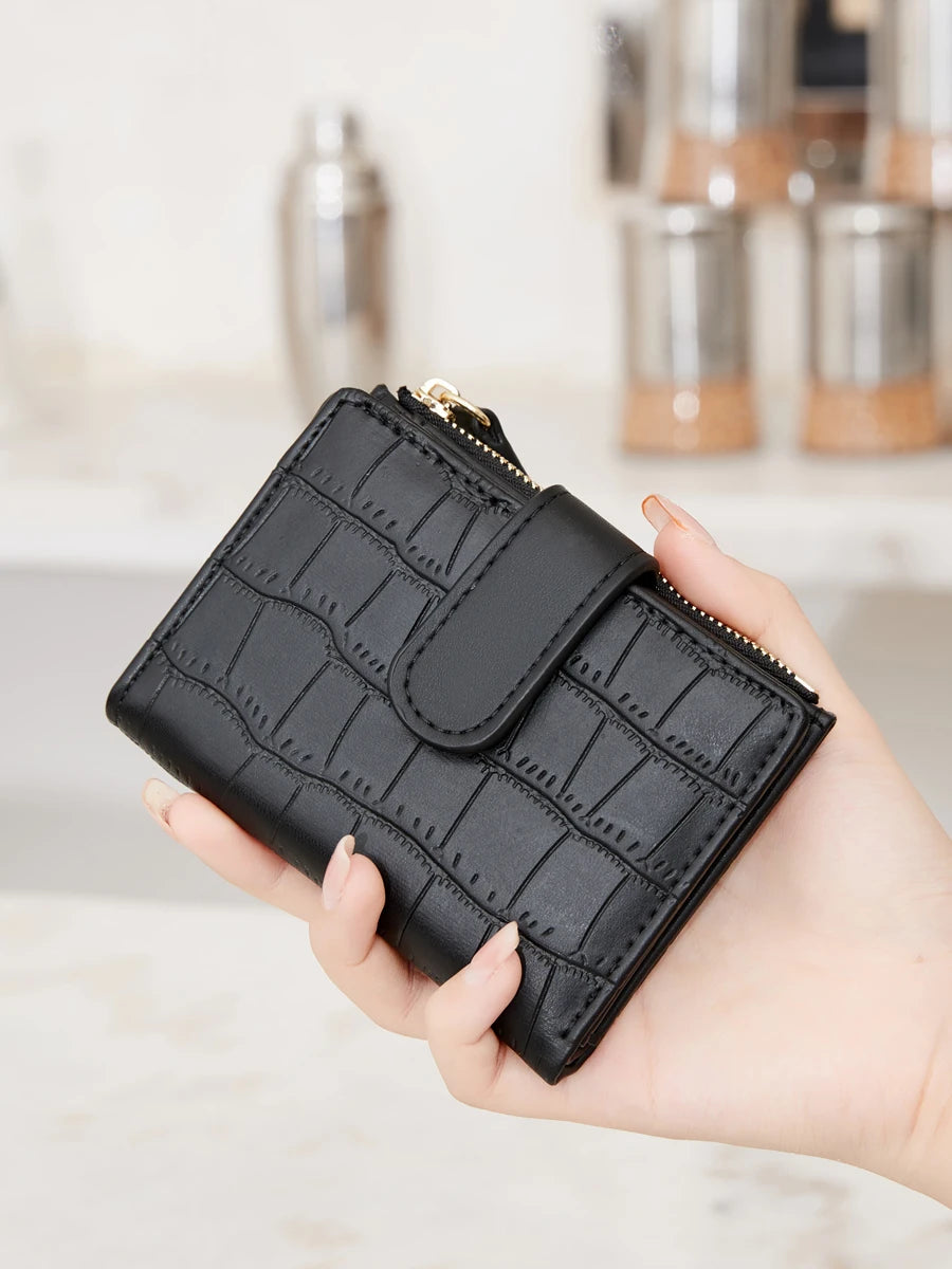 A hand holds a black PU leather bifold wallet with a gold zipper and ID window.