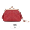 A red leather coin purse with a gold-toned clasp and chain attached to the top.