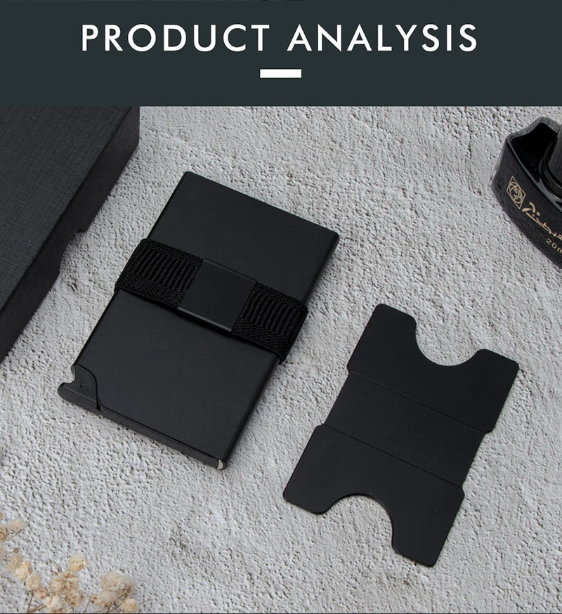 A black RFID blocking metal pop-up card wallet is shown on a light surface.