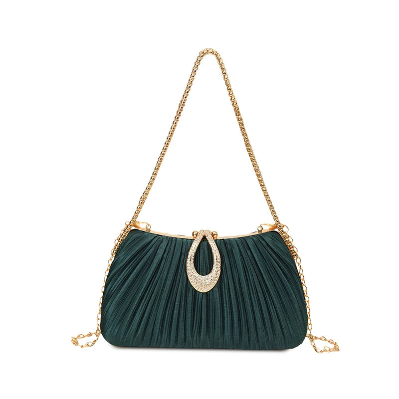 A dark teal pleated evening clutch bag with a gold chain strap and a rhinestone embellishment.