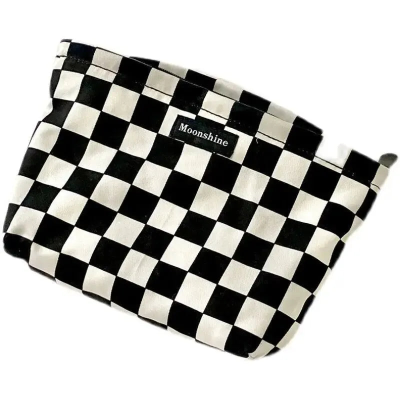 A black and white checkered cosmetic storage bag with Moonshine branding.