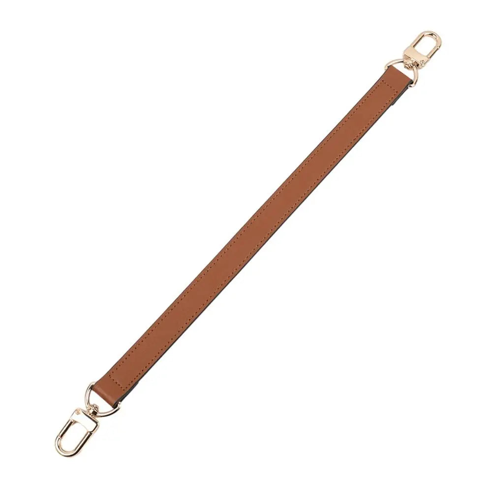 A brown genuine leather replacement shoulder strap with metal hardware.