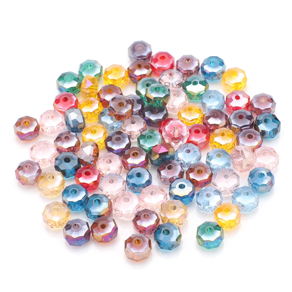 A pile of faceted crystal glass beads in various colors including pink, yellow, red, blue, and green.