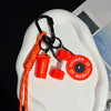 Orange and black D-shape nylon fitness keychain with a fitness weight and bottle attachment
