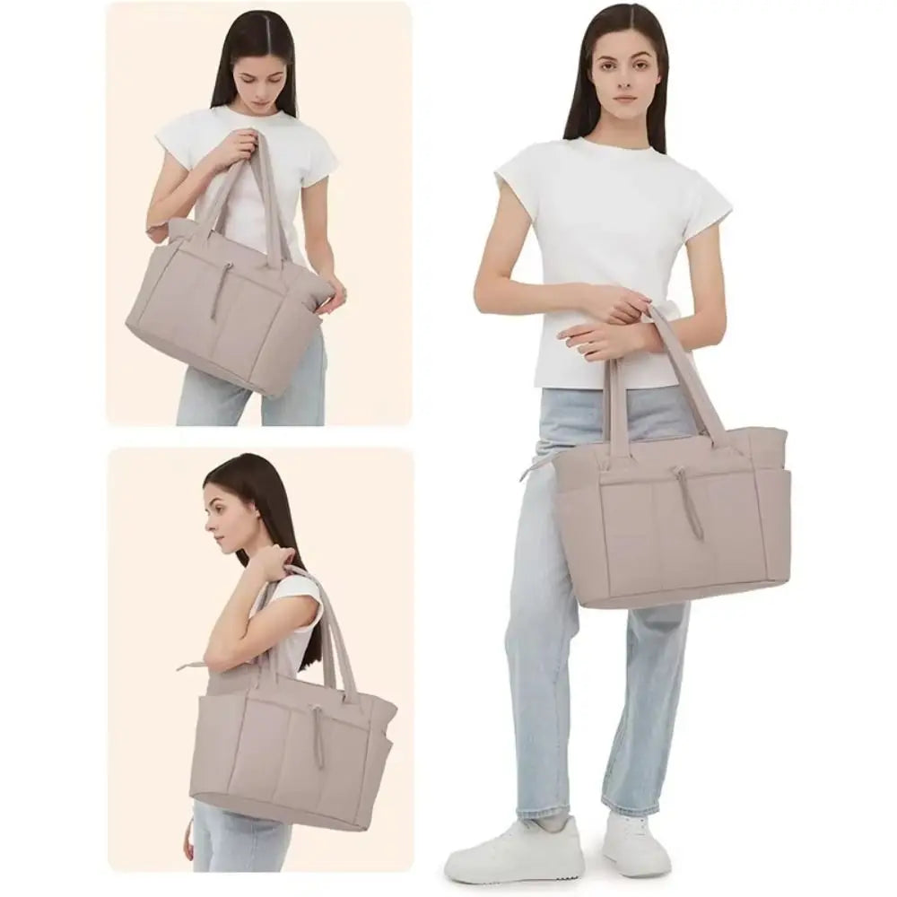 A woman holds a beige quilted padded tote bag with multiple pockets.