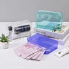A collection of clear and purple PVC travel makeup bags and a skincare product are displayed on a white surface.