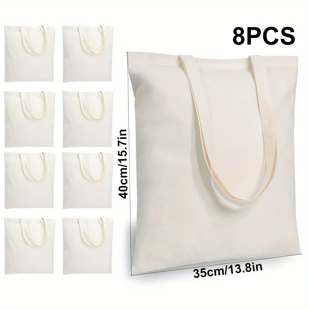 Huit sacs en toile de coton blancs en vrac, montrés dans différentes tailles et angles.