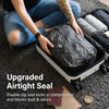 A person is placing a black vacuum storage bag into a white suitcase, demonstrating an upgraded airtight seal.