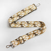 A beige and brown jacquard patterned strap for an adjustable wide crossbody bag.