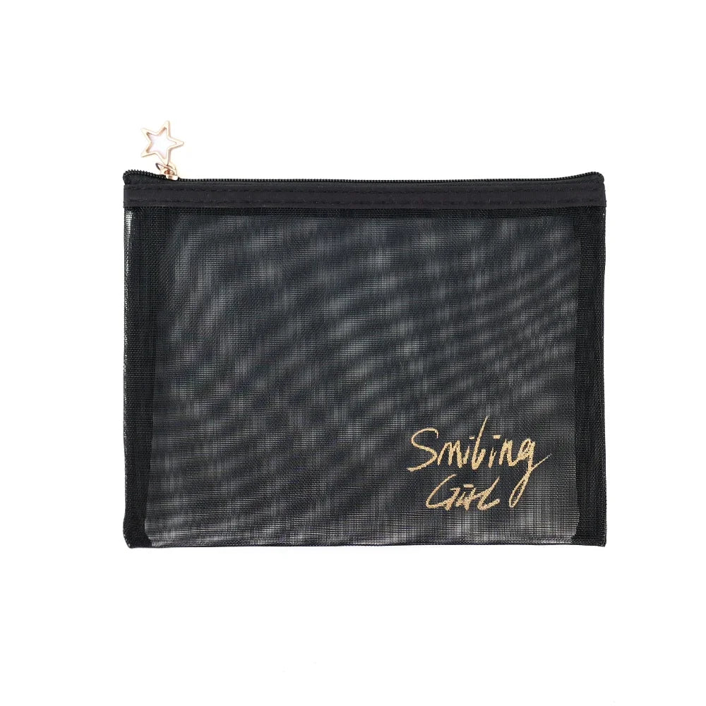 A black mesh travel cosmetic storage pouch with a gold star charm attached.