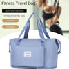 A light blue fitness travel bag with shoulder straps is shown on a white surface.