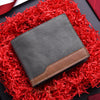 A dark gray PU leather men's wallet with a brown accent, resting on a vibrant red, fluffy material.