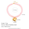 A pink bead necklace featuring a gold chain and a heart-shaped gold charm, made with resin and stainless steel.