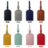 A row of eight PU leather luggage tags in various colors including black, gray, navy blue, brown, yellow, mint green, pink, a