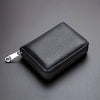 A black leather zipper card holder wallet shown from above on a dark gray surface.