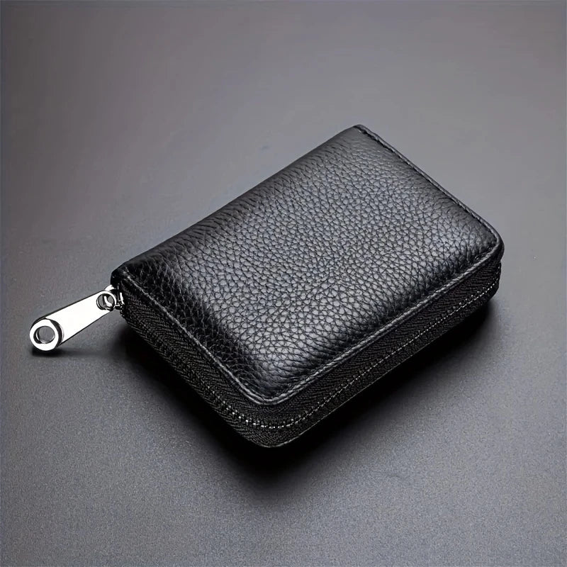 A black leather zipper card holder wallet shown from above on a dark gray surface.