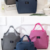 Three insulated canvas tote bags in gray, blue, and pink with Yanni branding displayed on a white surface.