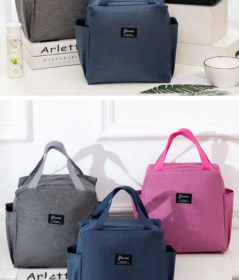 Three insulated canvas tote bags in gray, blue, and pink with Yanni branding displayed on a white surface.