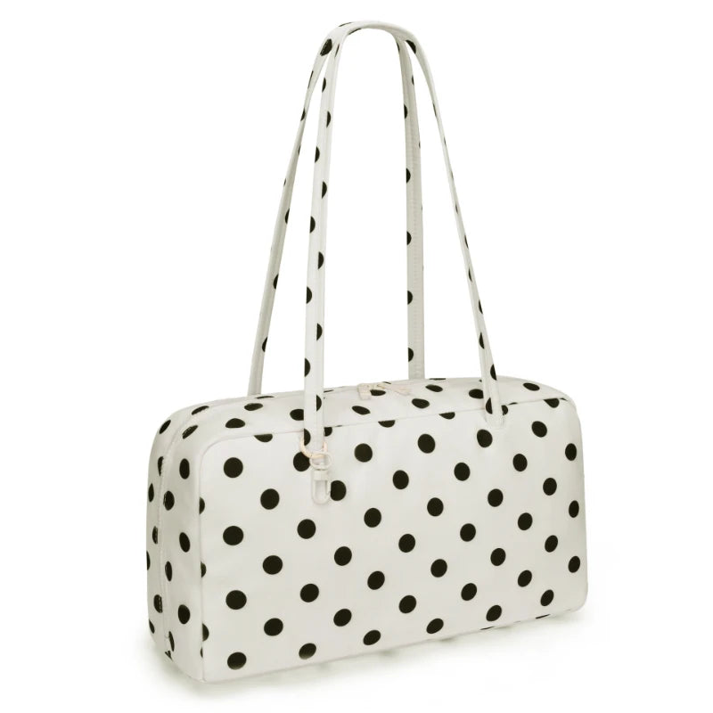 A white nylon shoulder tote bag with black polka dots.