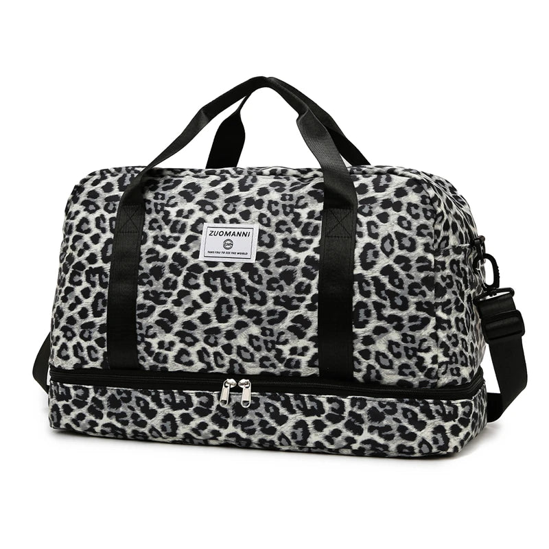 A black and white leopard print travel duffel bag with handles and a shoe compartment.