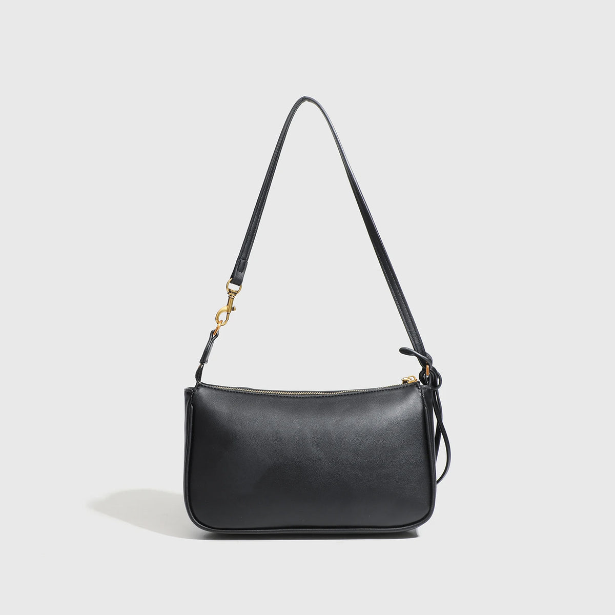 A black classic split leather shoulder tote bag with a gold-toned chain strap.