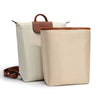 A beige satin bag organizer insert with a brown leather strap and matching pouch.