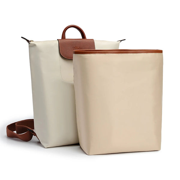A beige satin bag organizer insert with a brown leather strap and matching pouch.