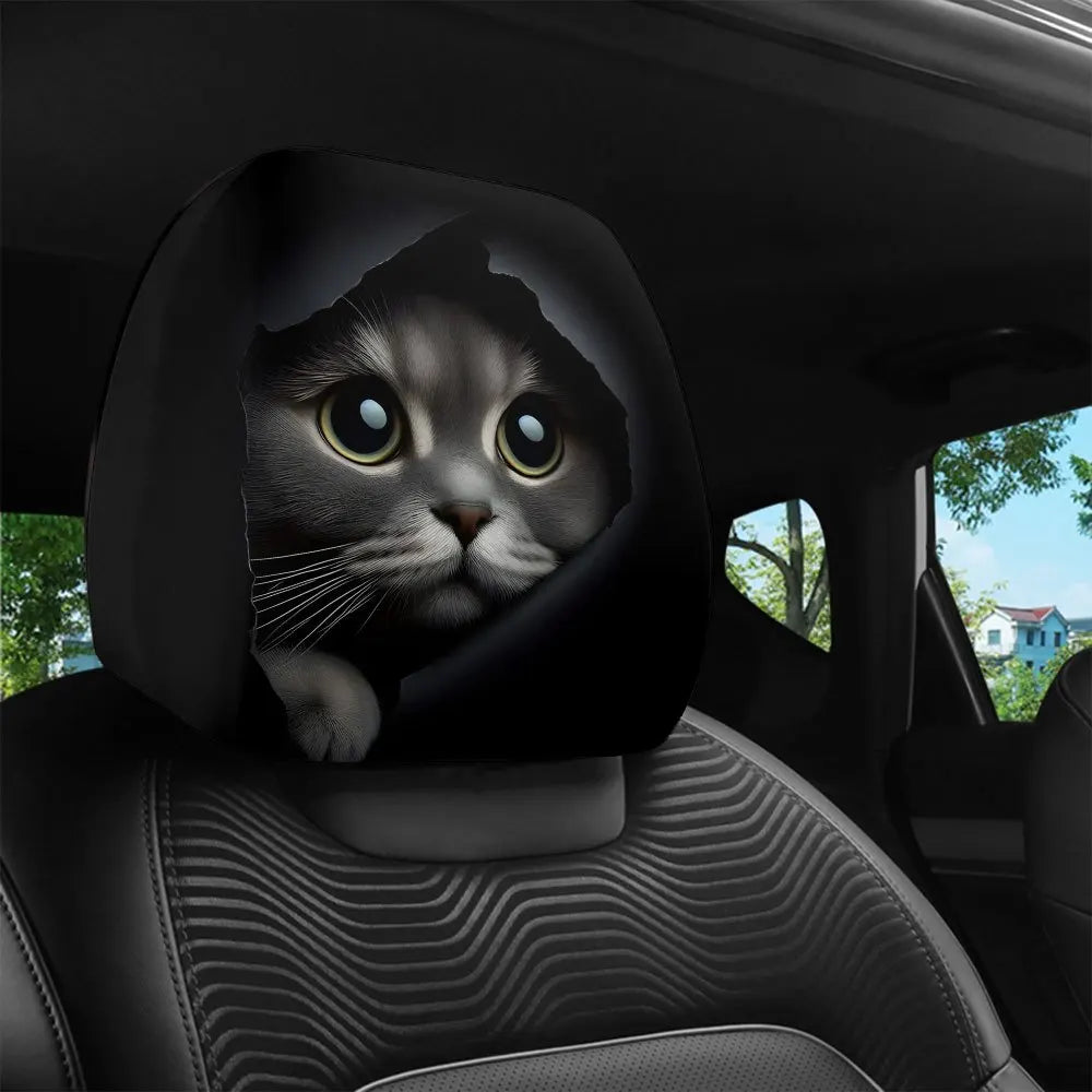 A black cat face printed on a car headrest cover in a car interior.